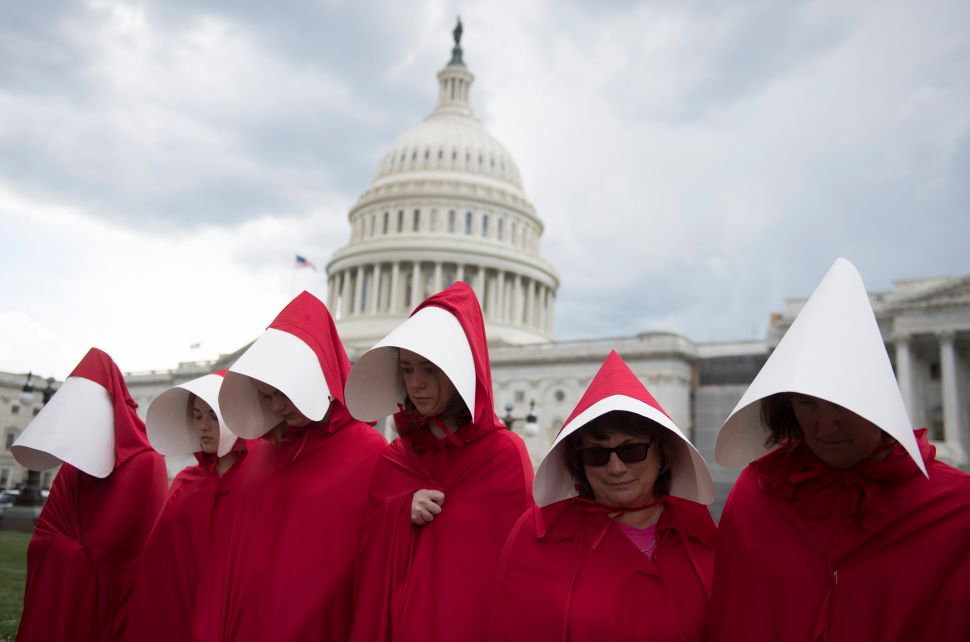 Supporters of Planned Parenthood dressed as characters from 'The Handmaid's Tale' hold a rally as they protest the U.S. Senate Republicans' health care bill outside the U.S. Capitol on June 27, 2017.