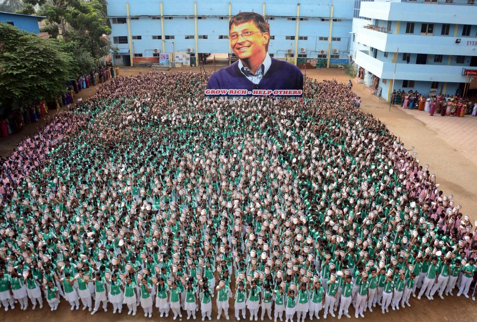 About 5,000 Indian schoolchildren hold up a cutout of Bill Gates to mark his 60th birthday at a school in Chennai on October 28, 2015.