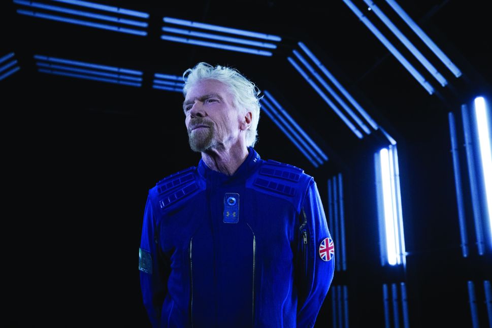 Virgin Galactic founder Richard Branson demonstrate Under Armour's custom made spacesuit.