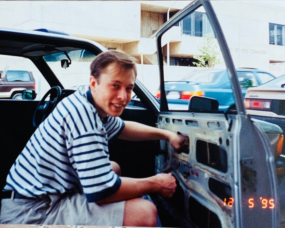 Elon Musk with his first car, a 1978 BMW 320i, in 1995.