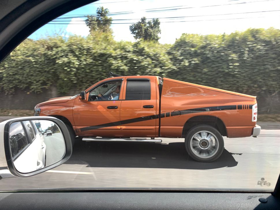 A Ram truck with a trunk styled like a Cybertruck.