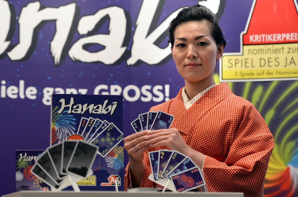 The card game Hanabi features collaboration among players and decision making based on incomplete information.