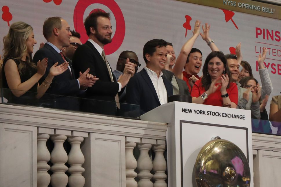 Pinterest CEO Ben Silbermann (center) and his coworkers ring the opening bell at the NYSE on April 18, 2019.