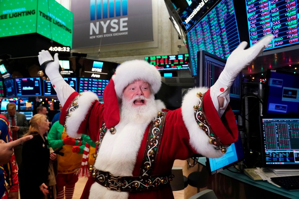 Santa Claus gestures on the floor at the closing bell of the Dow Industrial Average at the New York Stock Exchange on December 5, 2019 in New York.