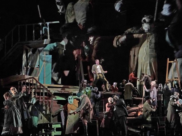 Peter Mattei among the gas-masked revelers in 'Wozzeck'.