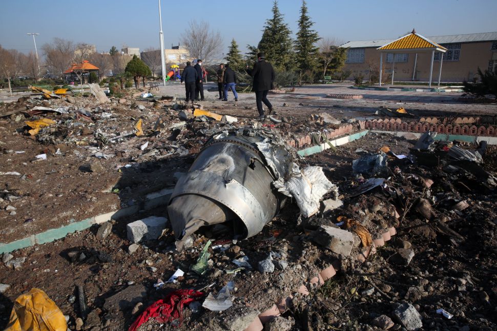 Rescue teams work amidst debris after a Ukrainian plane carrying 176 passengers crashed near Imam Khomeini airport in the Iranian capital of Tehran early in the morning on January 8, 2020, killing everyone on board.