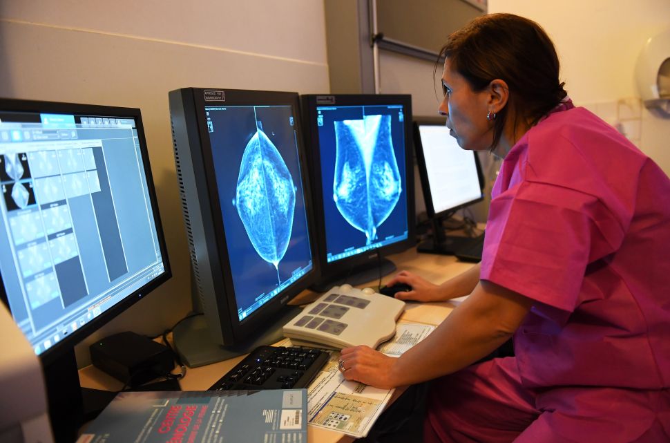 A doctor looks at the results of a mammography.
