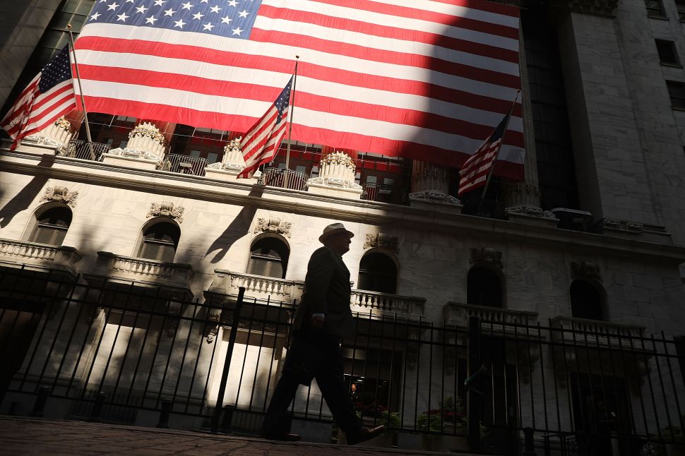 A man walks by the New York Stock Exchange (NYSE) on July 12, 2018 in New York City.
