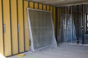 The yellow-ish Sto Gold Coat on concrete blocks and triple-pane windows will help maintain temperatures indoors (Photo: Molly Stromoski/ For Commercial Observer). 