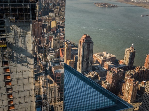 Construction of 3 WTC, seen in the reflection of 4 WTC, is slated to top out later this year. The tower is already 28 percent leased (Photo: Sasha Maslov/for Commercial Observer). 